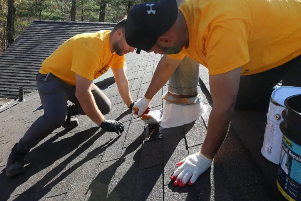 Roof Roof Renewal crew working around a roof penetration